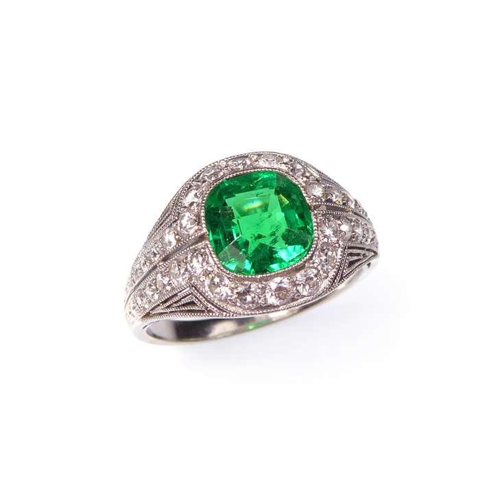 Cushion cut emerald and diamond cluster ring